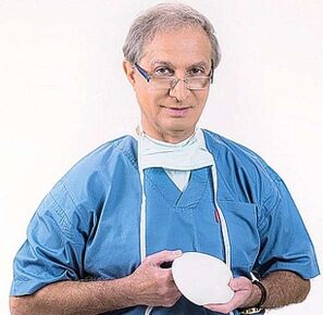The doctor holds an implant to enlarge the breast